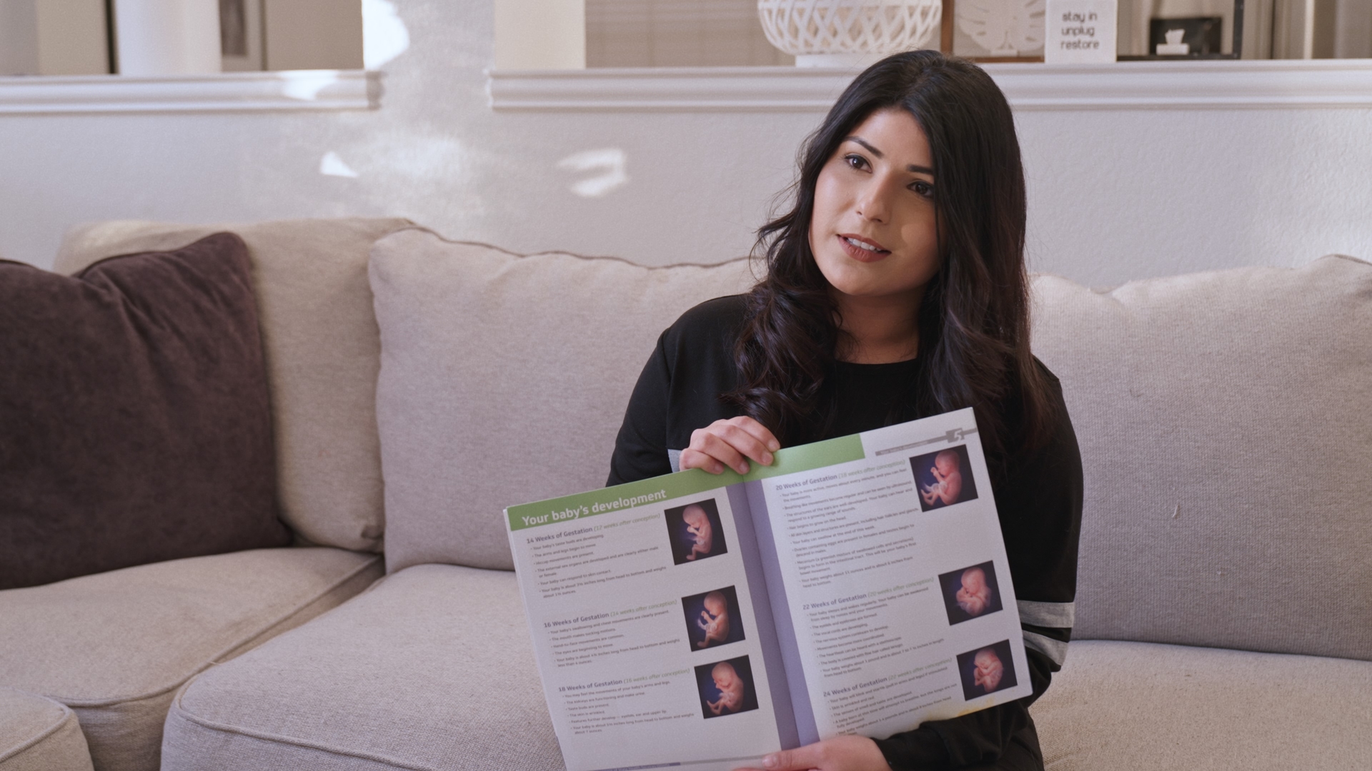 Maleeha showing a pamphlet
